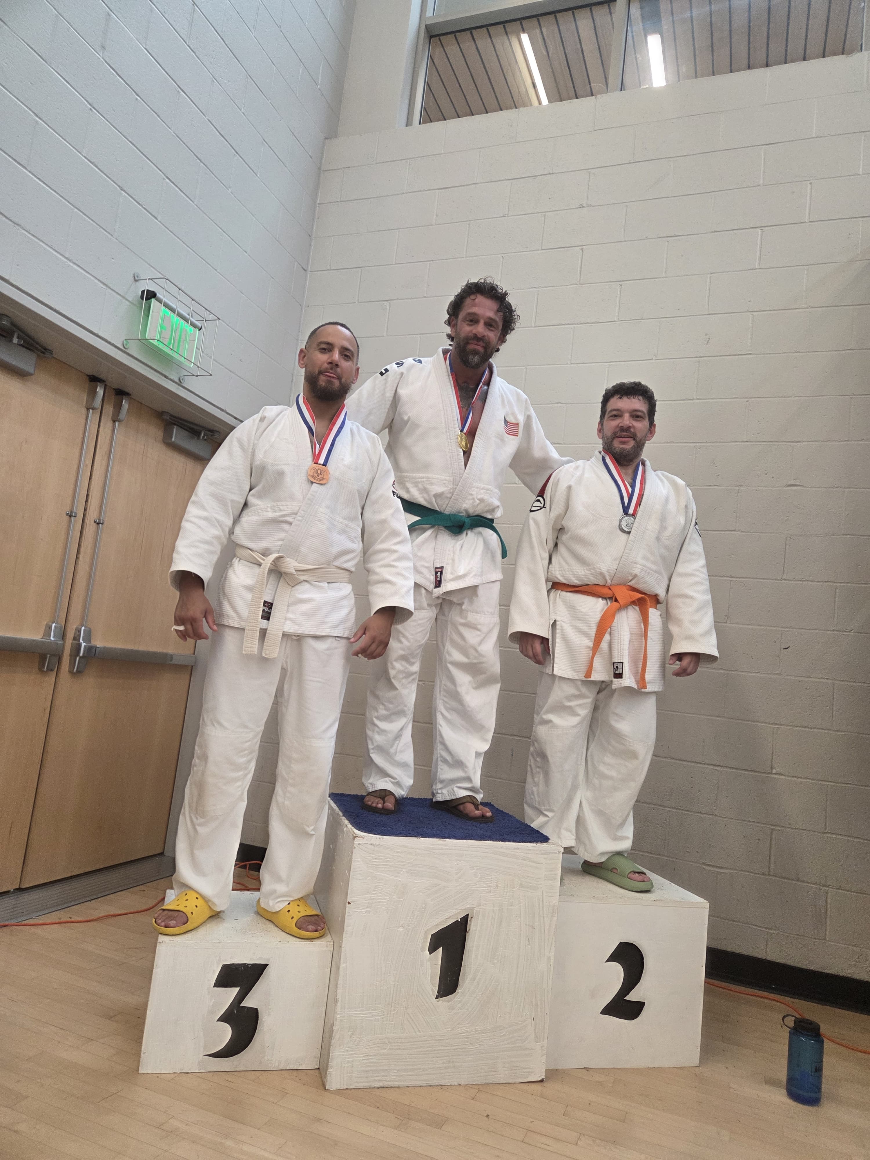 NYBBC Judo adult competitors on the medal podium